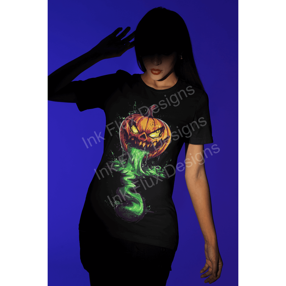 Woman in black Halloween t-shirt with glowing pumpkin design against a blue background