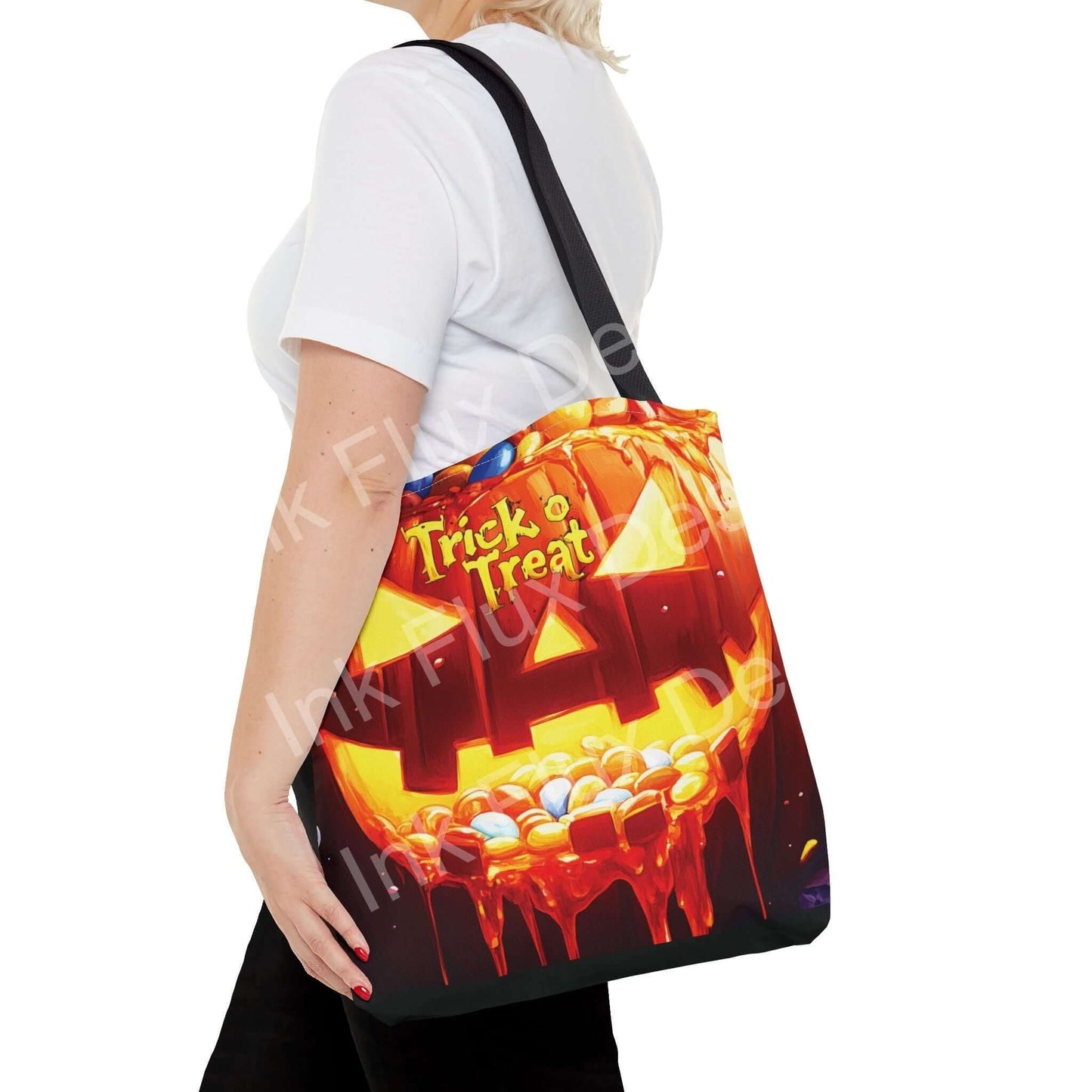 Woman carrying a Jack o Lantern II tote bag, showcasing vibrant trick-or-treat design and sturdy black straps.