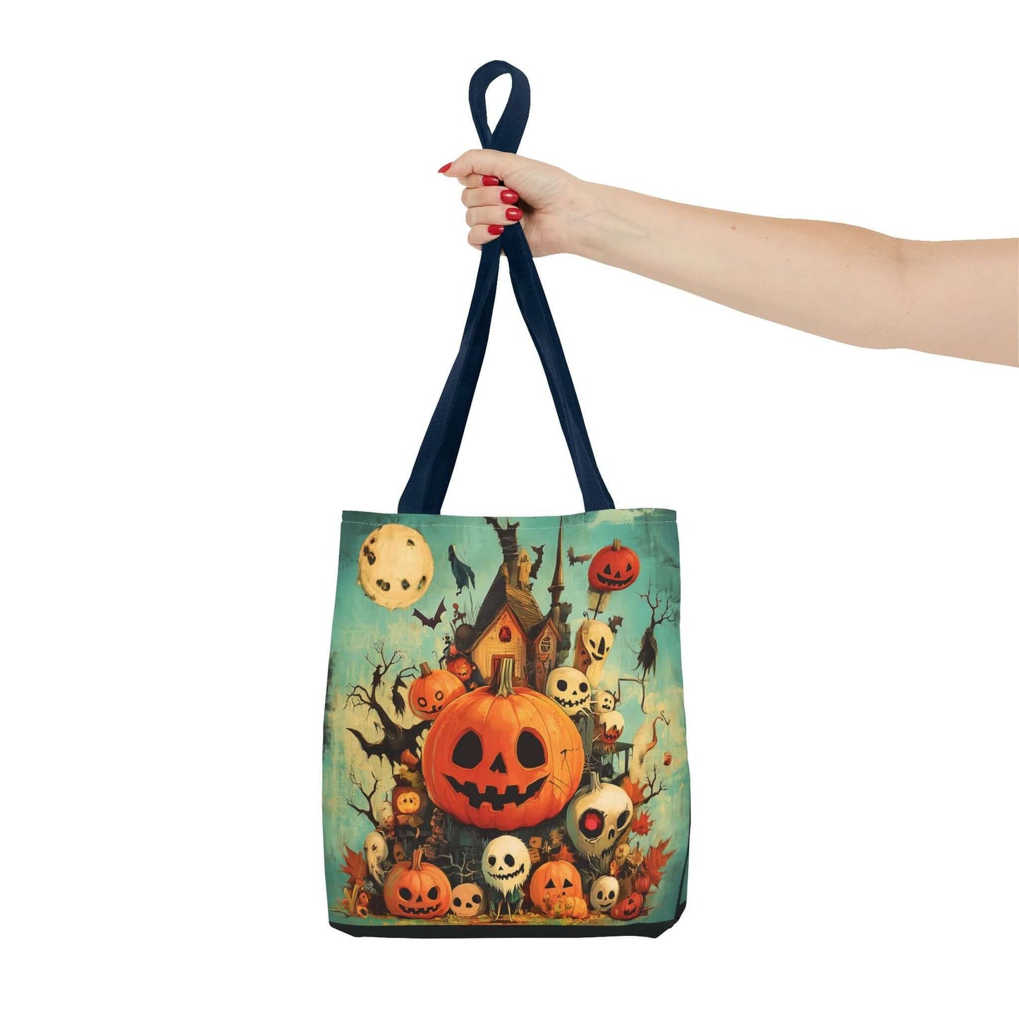 Woman's hand holding a Jack o' lanterns on porch themed tote bag with multiple handle colors and high-end visuals, perfect for Halloween.