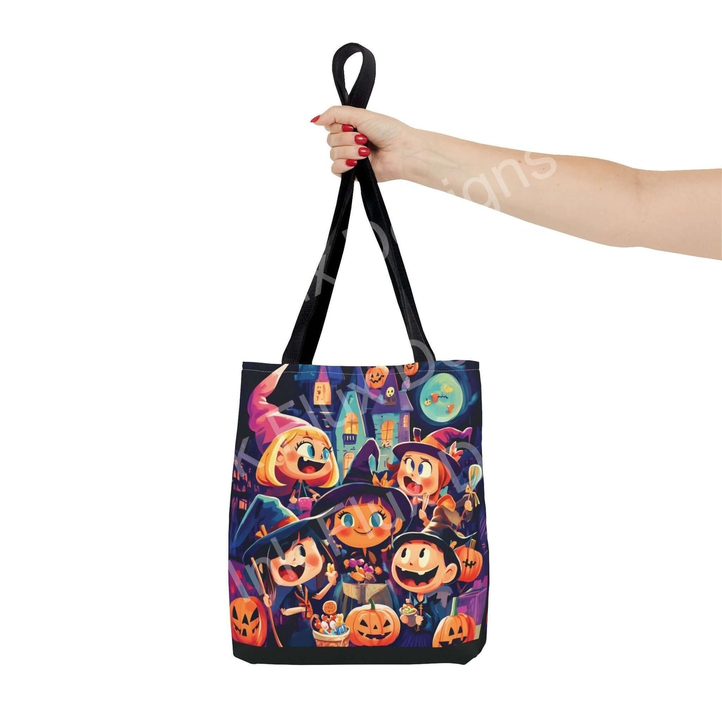 Hand holding a Little Witches all-over print tote bag, featuring colorful witch and pumpkin designs, available in multiple sizes and handle colors.