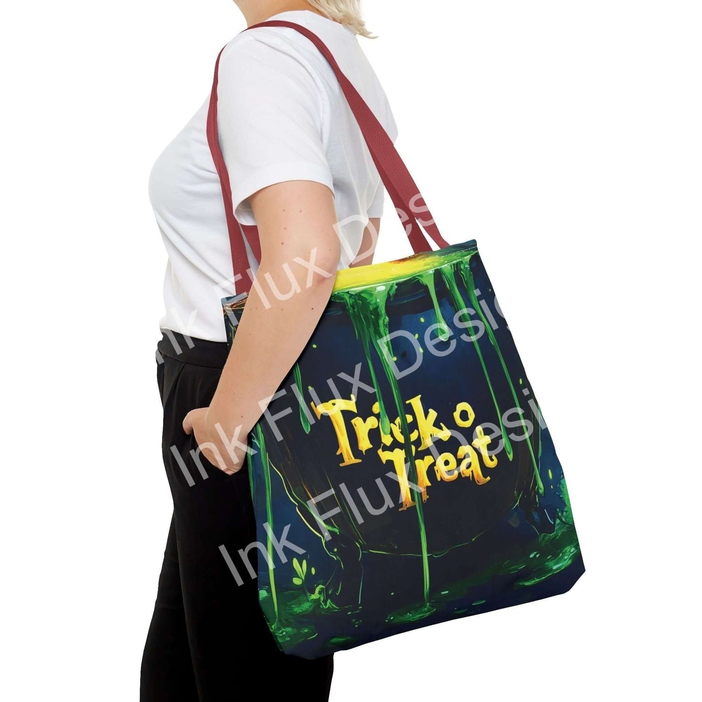 Woman carrying a large "Trick or Treat" all-over print Witch Cauldron Tote Bag with red straps, designed with vibrant Halloween-themed graphics.