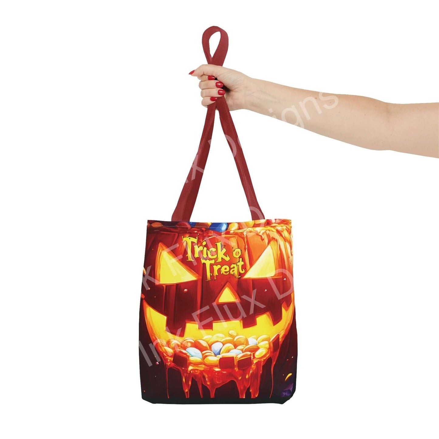 Hand holding a Jack o Lantern II all-over print tote bag with durable red straps, perfect for trick-or-treating and stylish accessory needs.
