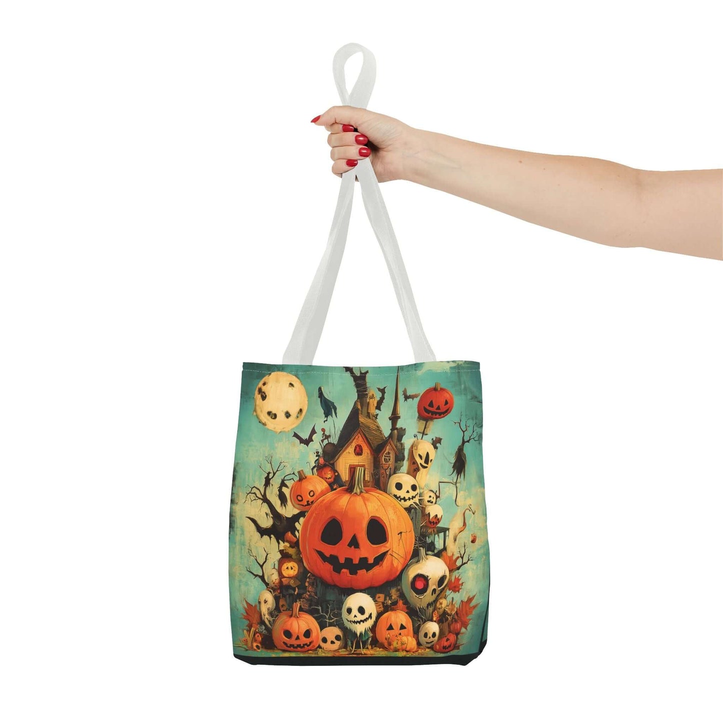Woman's hand holding a Jack o' lanterns on porch tote bag with colorful Halloween-themed all-over print design, made with durable polyester.