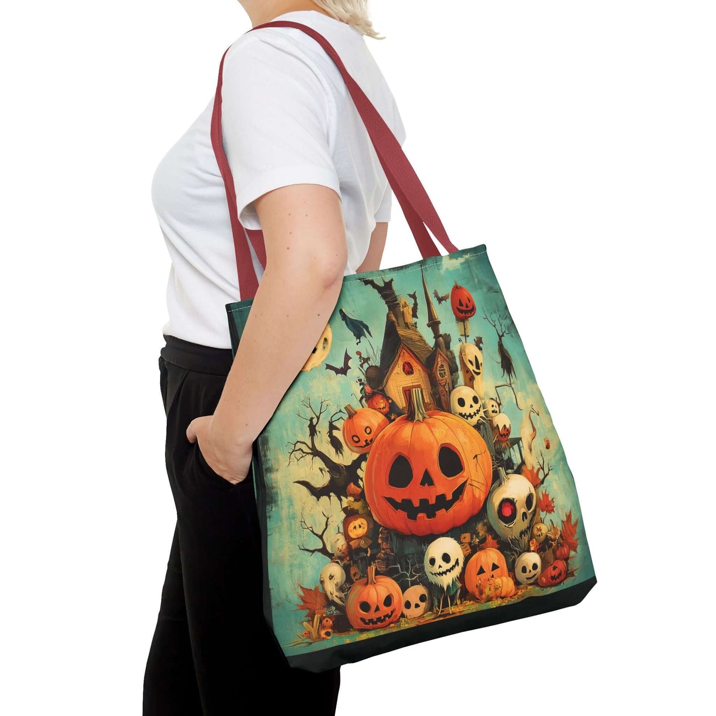 Woman carrying a Jack o' lantern themed tote bag featuring Halloween graphics, with adjustable red straps, available in multiple sizes and handle colors.