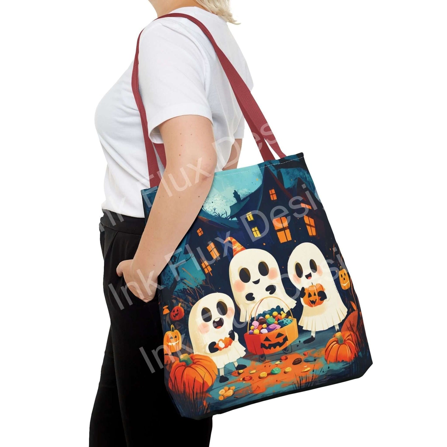 Woman carrying a Little Ghost Tote Bag featuring an all-over print of cute ghosts and pumpkins, with red straps and durable polyester fabric.