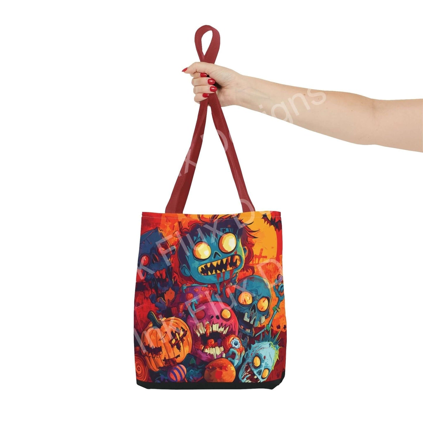Hand holding a Little Zombies all-over print tote bag with vibrant colors and multiple spooky characters, featuring red handles and polyester material.