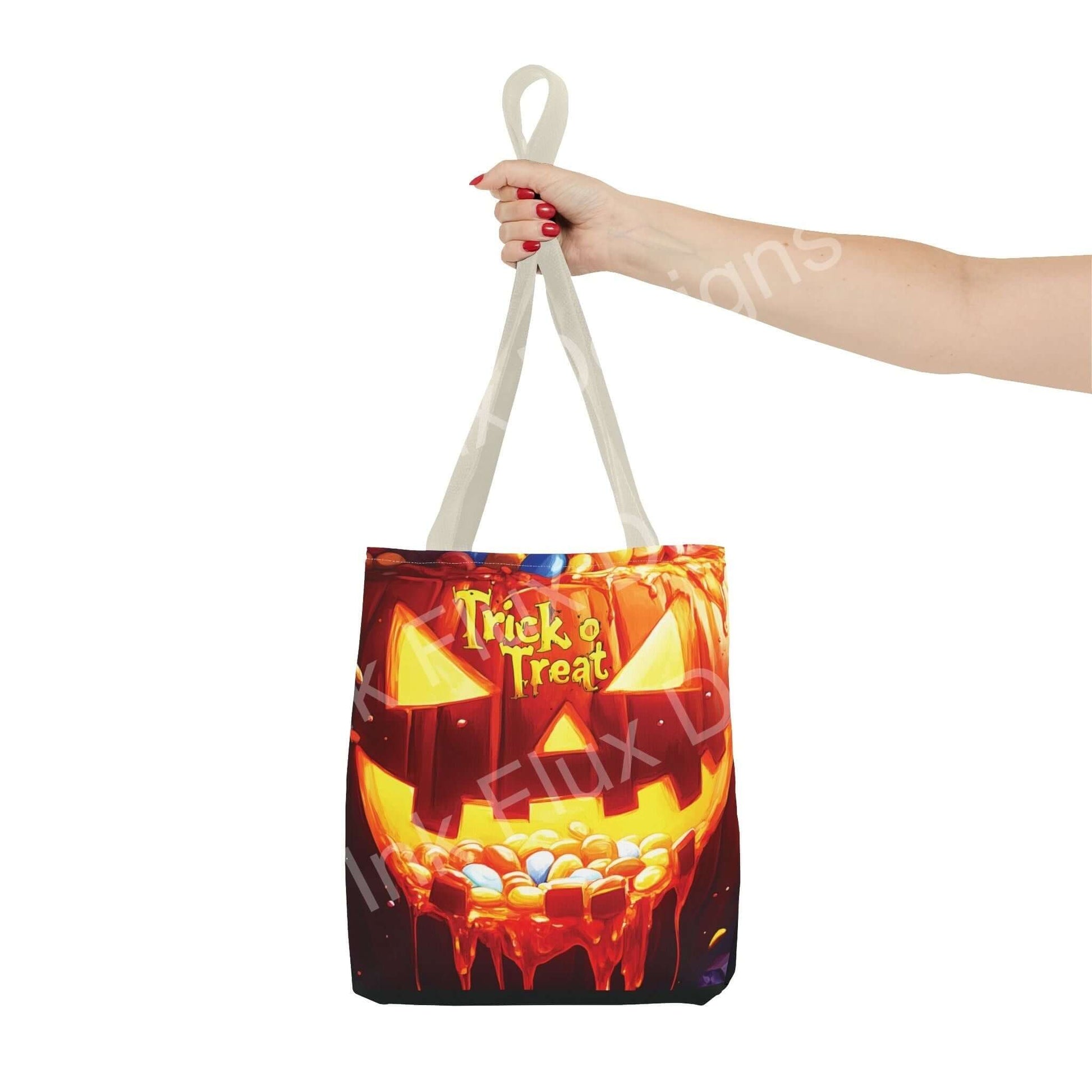 Woman holding a Jack o Lantern II Tote Bag with vibrant trick or treat design, made from durable polyester, ideal for Halloween.