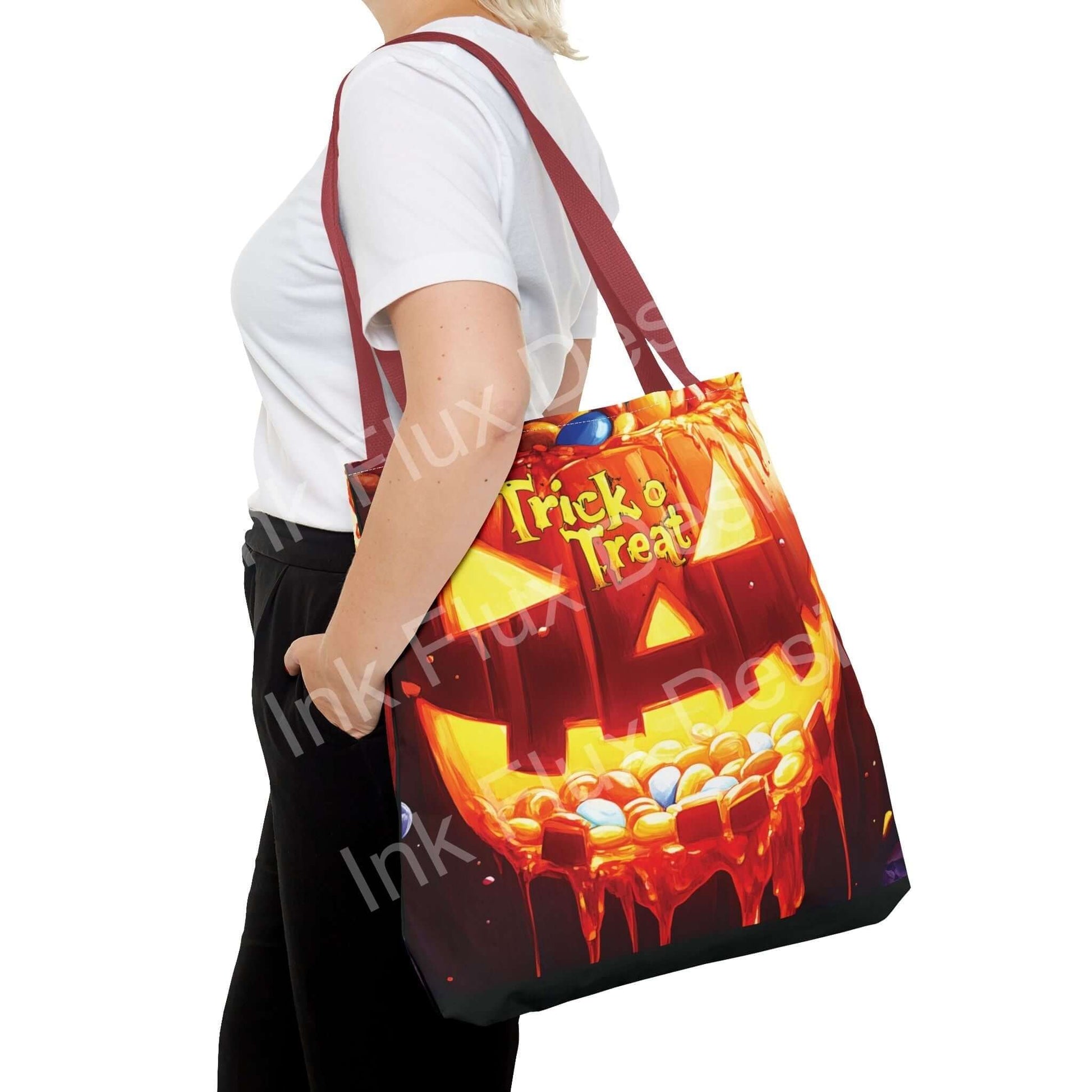 Woman carrying a Jack o Lantern II Tote Bag with vibrant Trick or Treat design, showcasing adjustable red handles and durable polyester material.