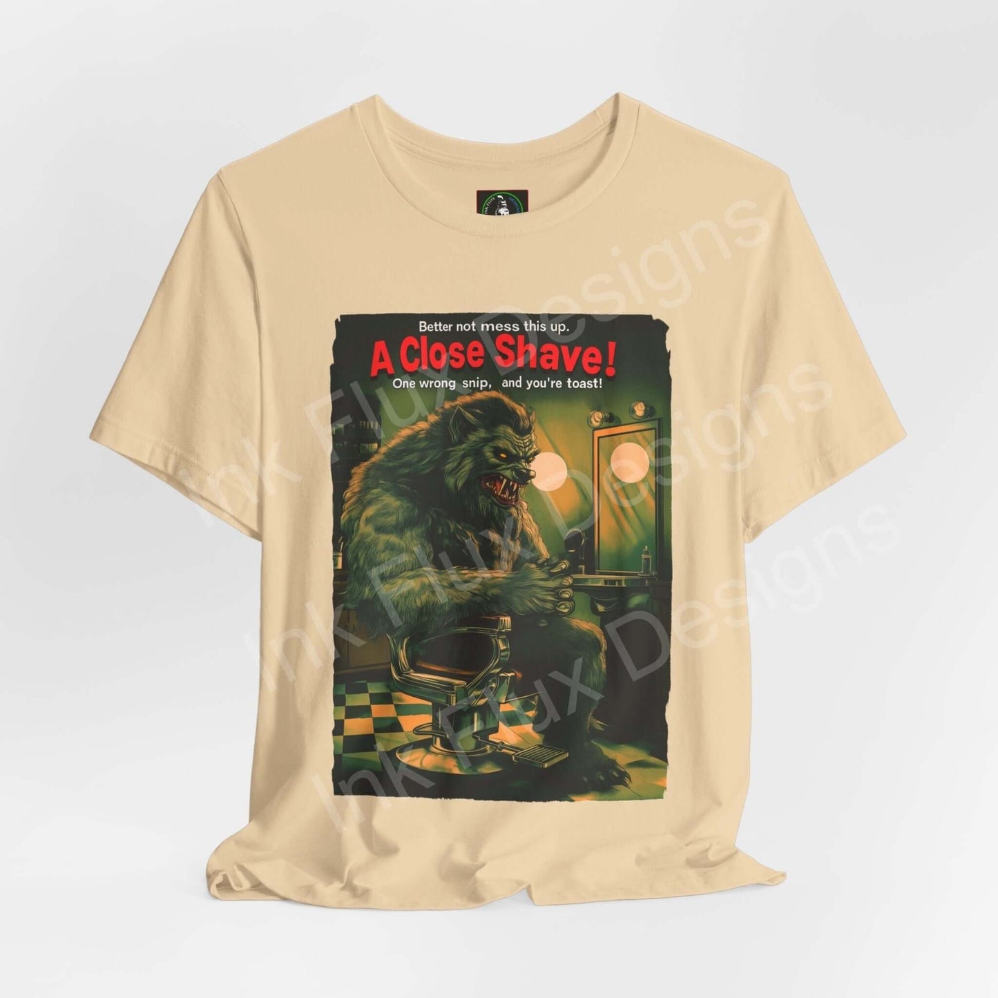 Halloween-themed "A Close Shave!" graphic tee, featuring a vintage horror-inspired design on a unisex beige T-shirt, by Bella+Canvas.