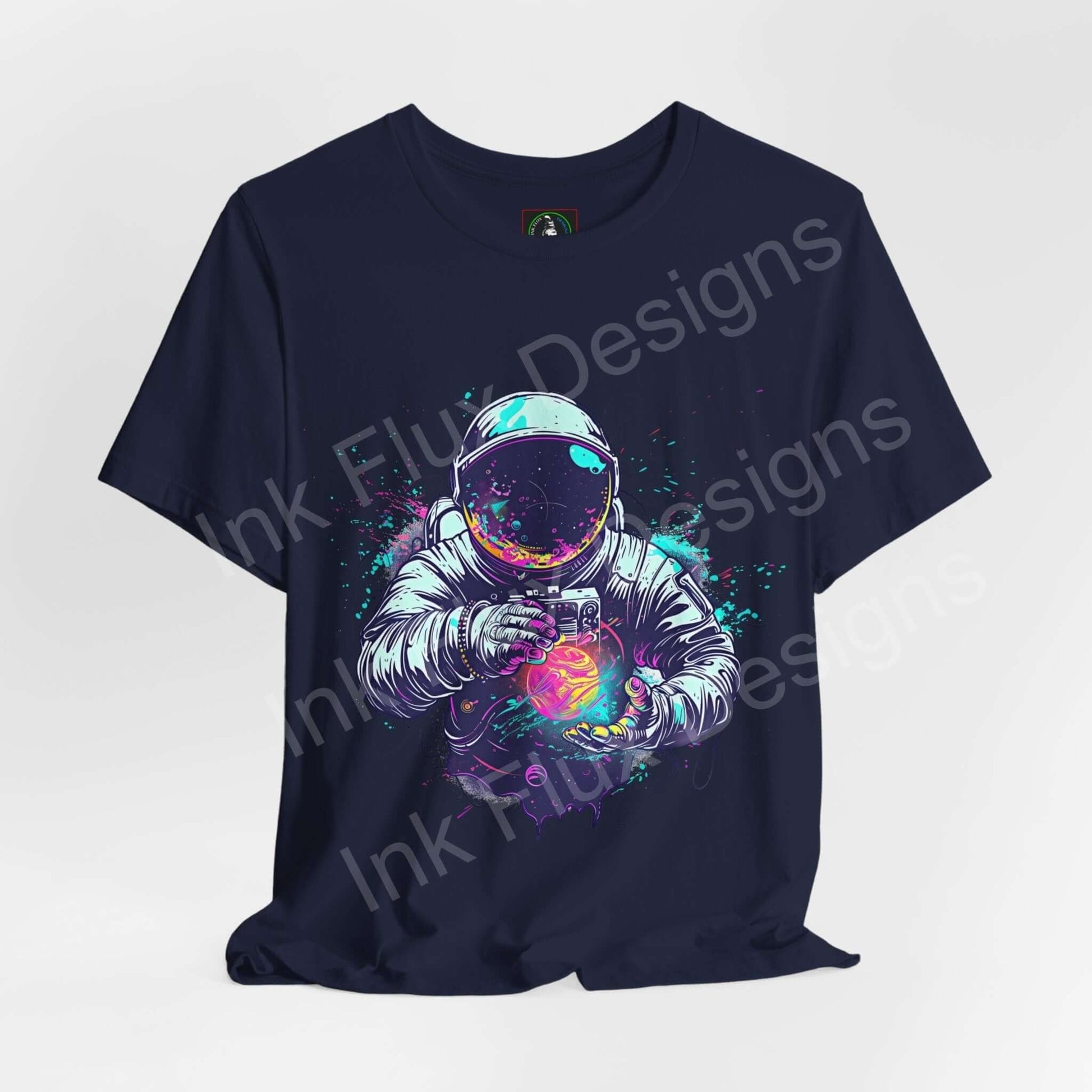 Navy unisex T-shirt with bold graphic of an astronaut holding a colorful, glowing orb, made from breathable Airlume cotton by Bella+Canvas.