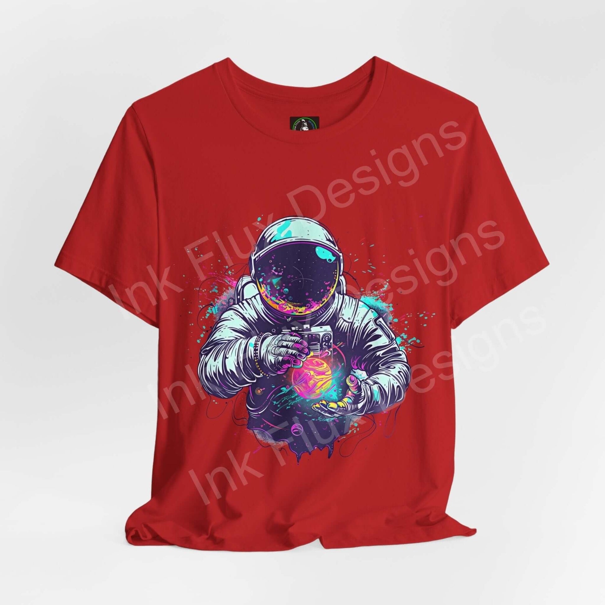 Red unisex T-shirt featuring bold graphic of an astronaut holding a vibrant, glowing orb, designed for style and comfort by Bella+Canvas.