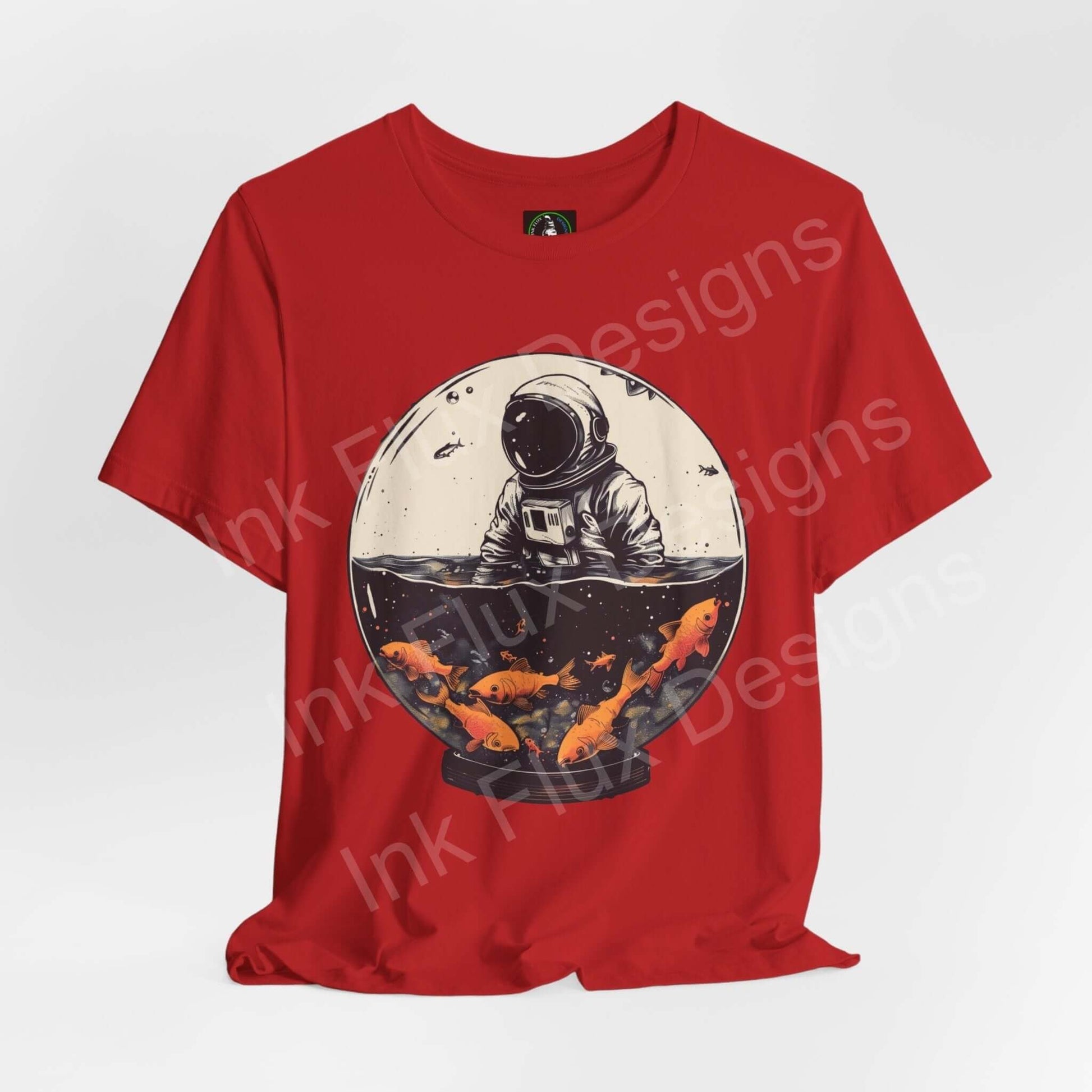 Red unisex T-shirt featuring a bold graphic of an astronaut in a fish globe, crafted from soft Airlume cotton by Bella+Canvas, ideal for style and comfort.