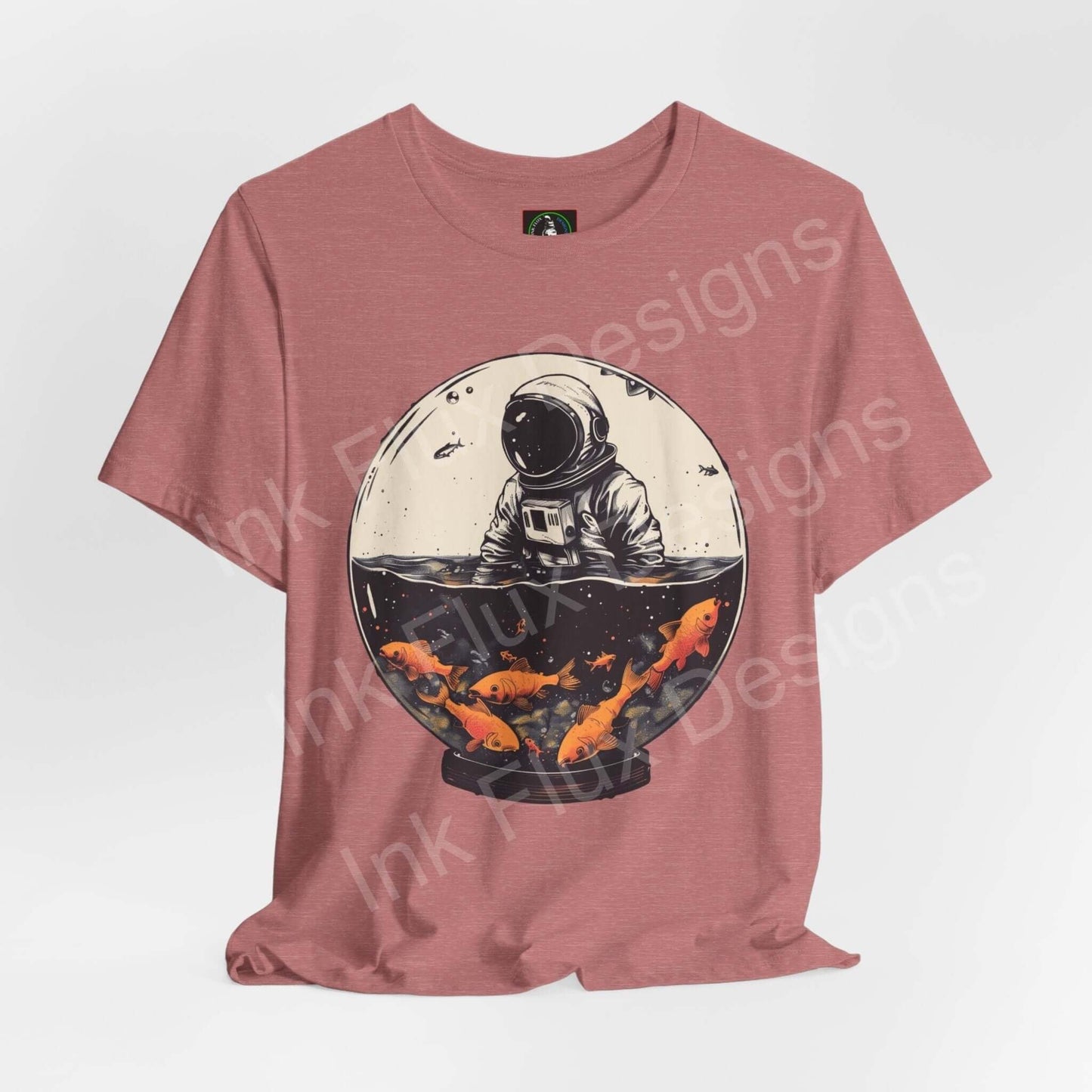 Unisex rose-colored T-shirt featuring a bold graphic of an astronaut in a fish globe, showcasing vibrant orange koi and a stark black backdrop.