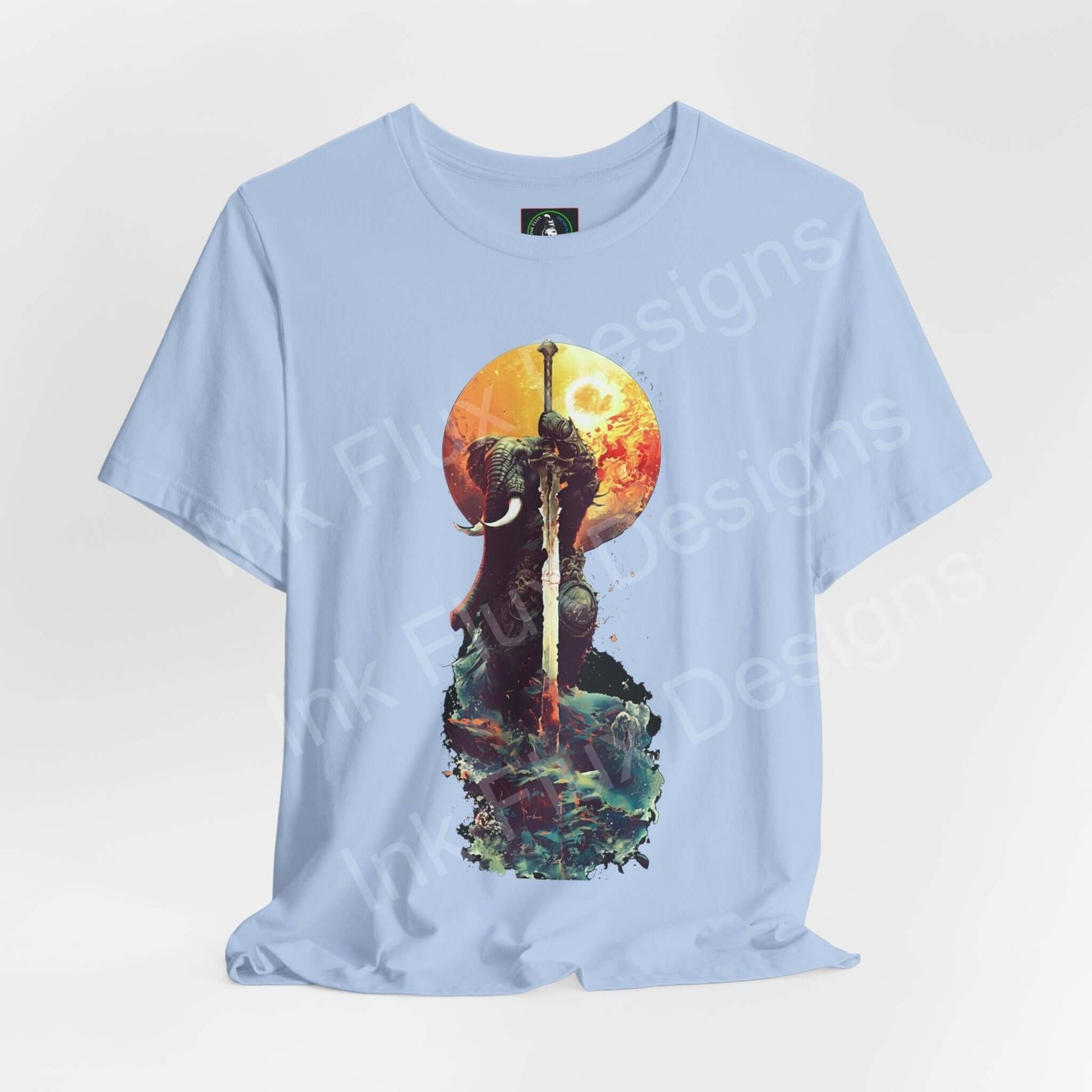 Light blue graphic tee featuring a battle-worn elephant warrior design under a vibrant sunset, made from soft Airlume cotton.