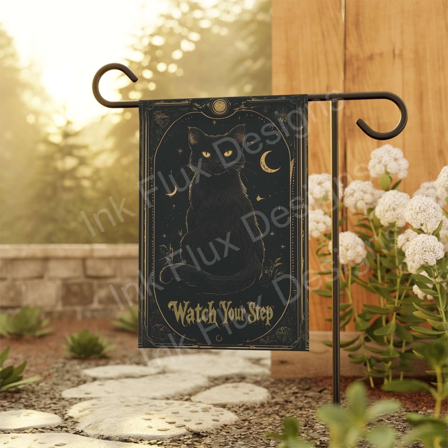 Double-sided black cat garden banner displayed on metal stand in a serene garden, perfect for Halloween decor.