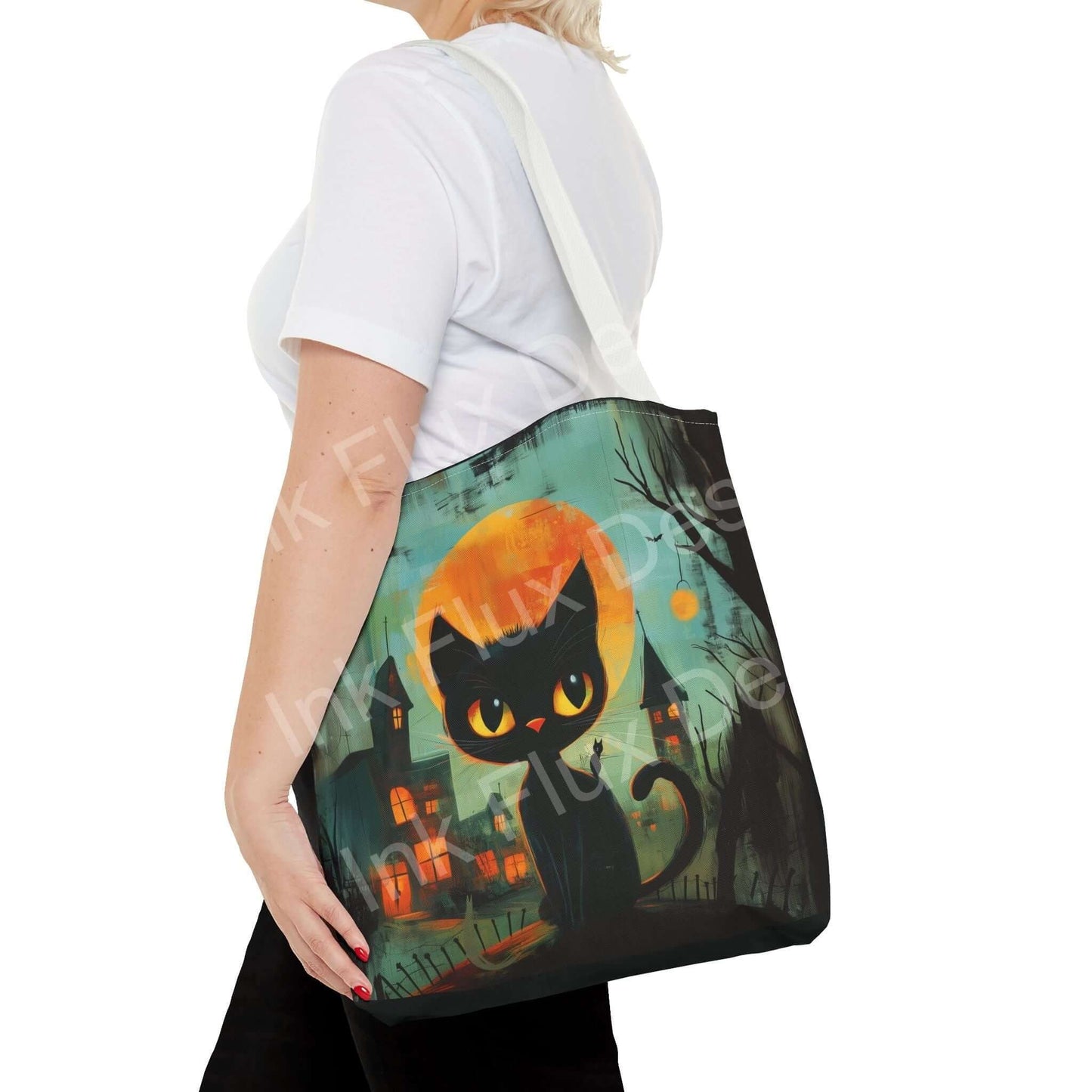 Woman carrying a black cat painting tote bag with vibrant all-over print design, showcasing a spooky urban backdrop.