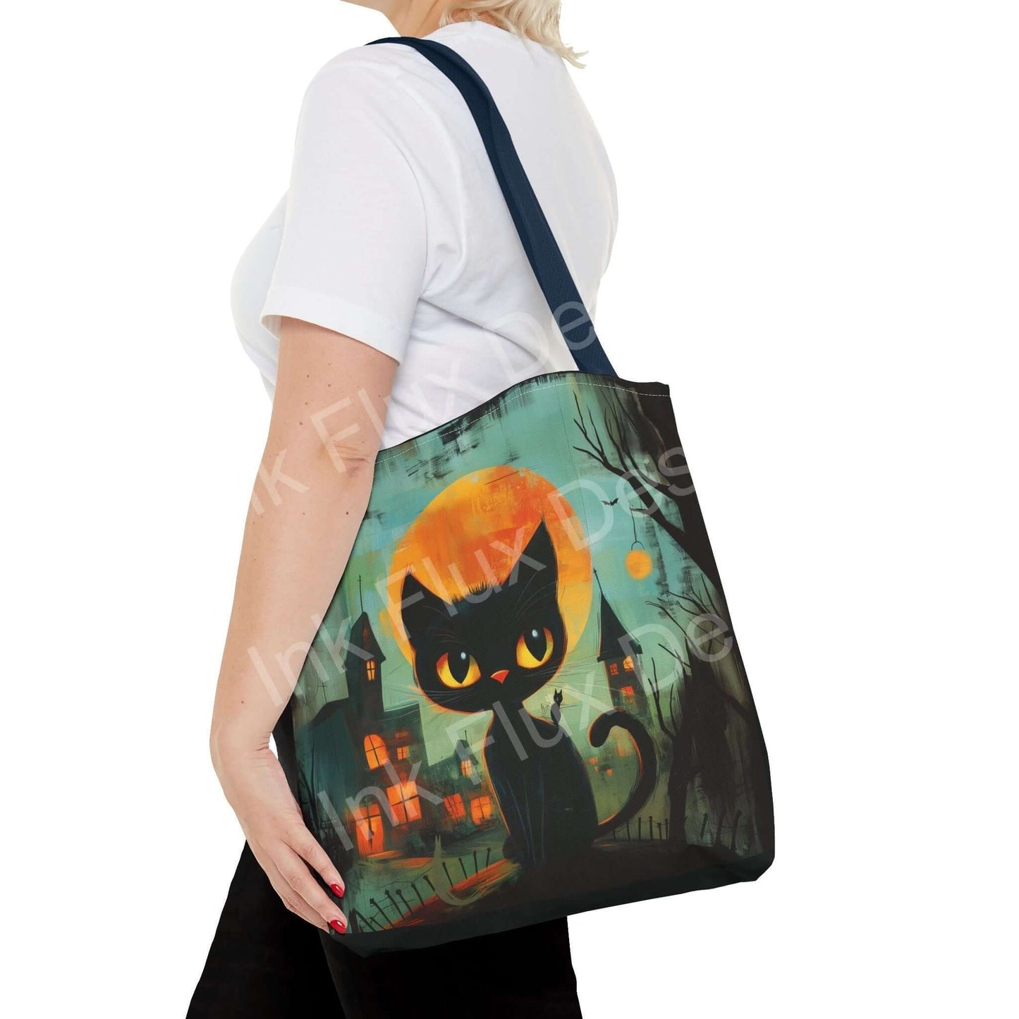 Woman carrying a black cat painting tote bag with orange strap, featuring an all-over spooky cityscape design.