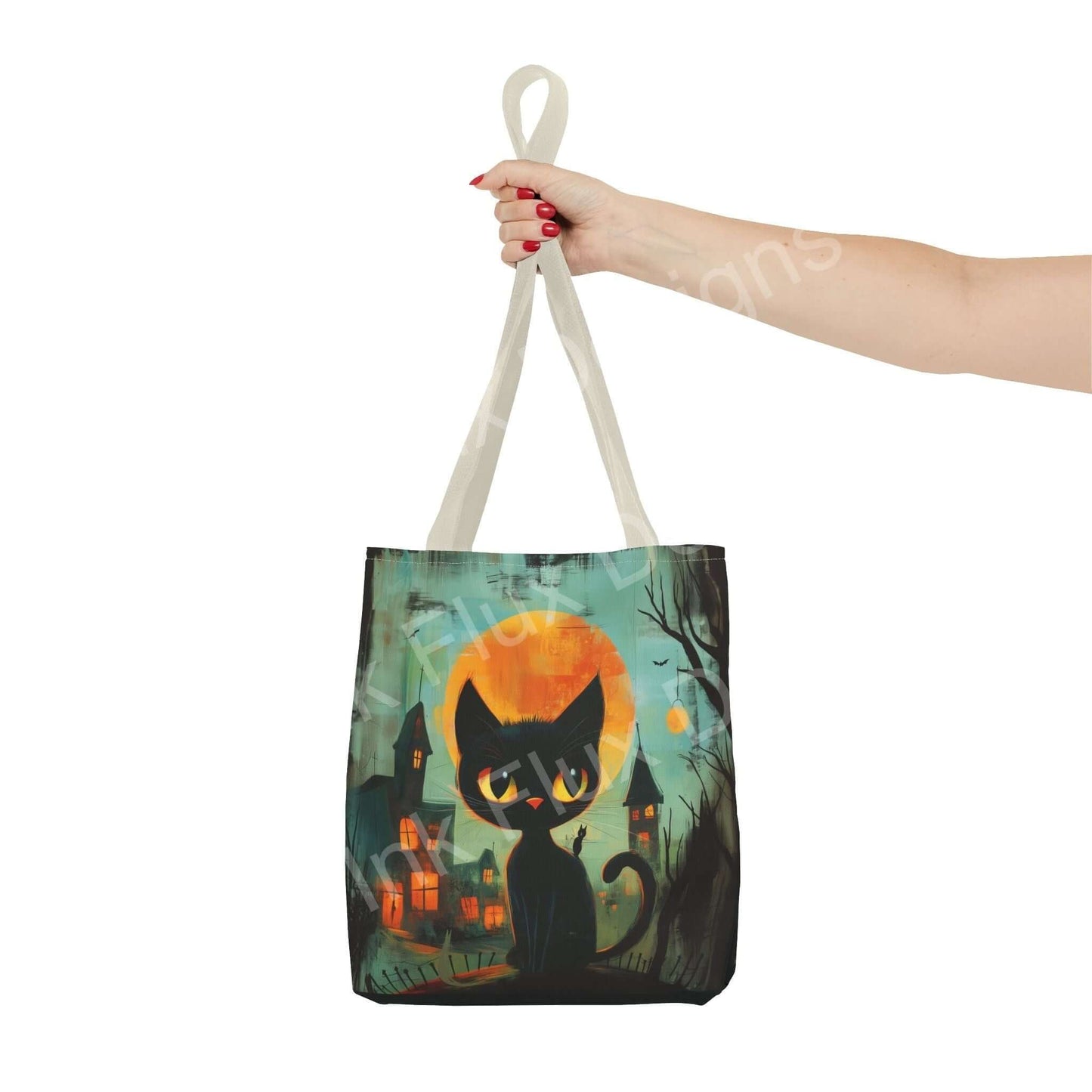 Person holding a tote bag featuring an all-over print of a black cat and spooky town under a full moon, made from durable polyester.
