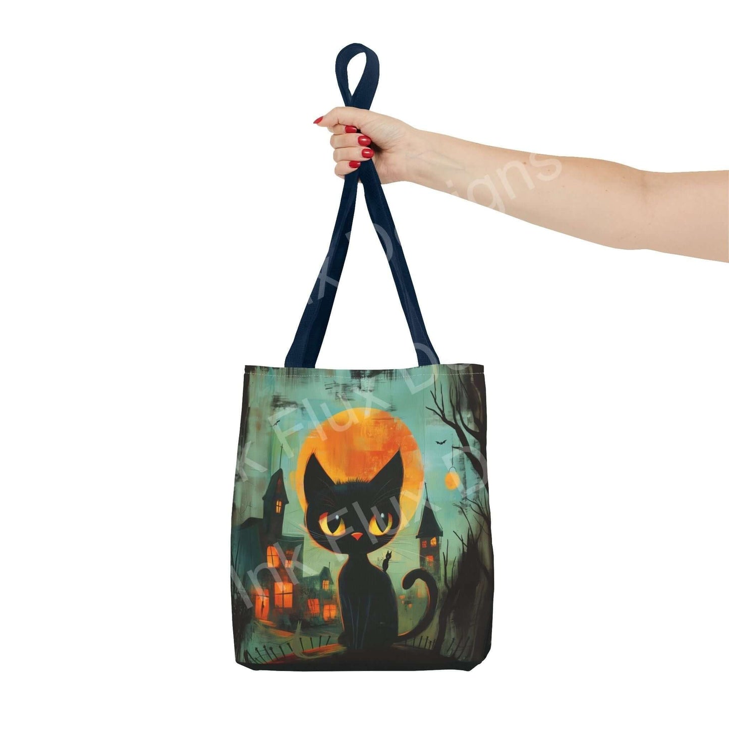 Stylish tote bag featuring an all-over print of a black cat and whimsical town, held by a hand with red nail polish, enhancing both function and fashion.
