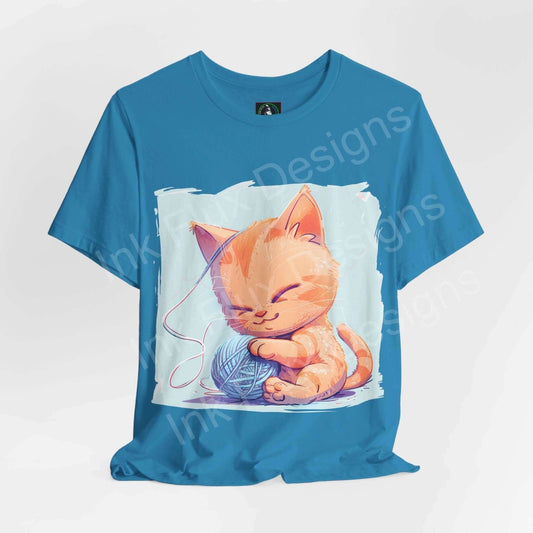 Blue graphic tee featuring a cute orange cat playing with yarn, ideal for T-shirt lovers looking for a casual and stylish look.
