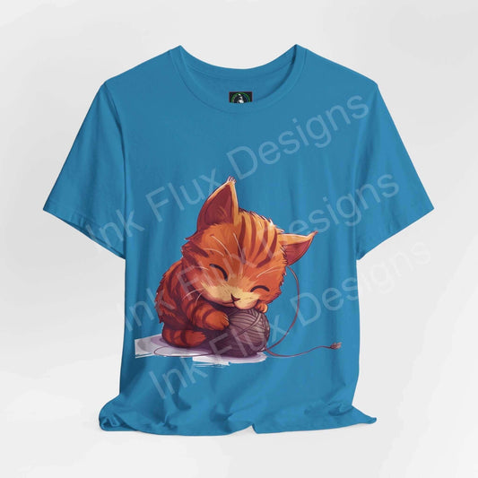 Blue unisex T-shirt featuring a graphic of a cute orange cat playing with yarn, ideal for cat lovers and suitable for casual wear.