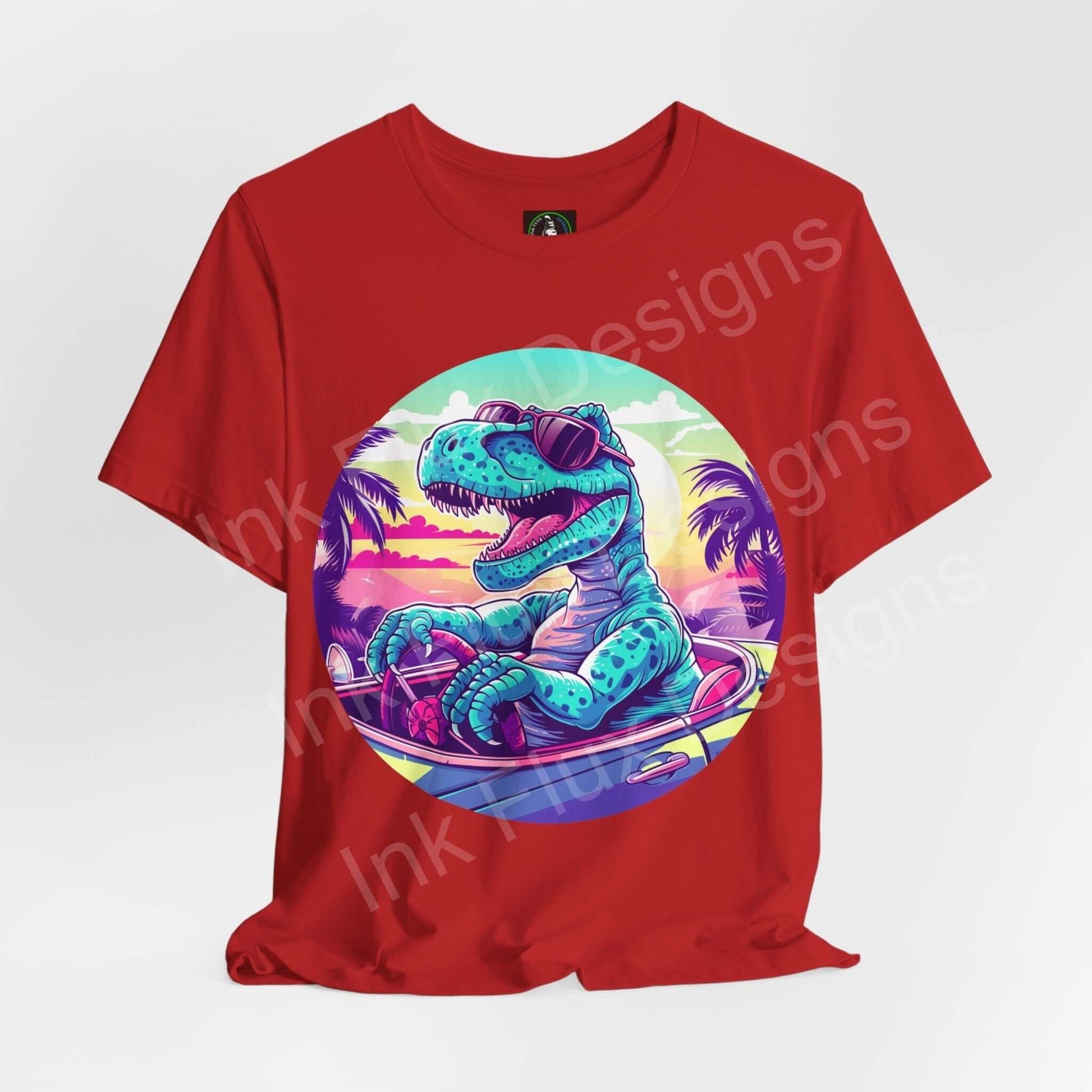 Red unisex jersey T-shirt featuring a bold graphic of a cruising dinosaur in a tropical sunset, crafted by Bella+Canvas.