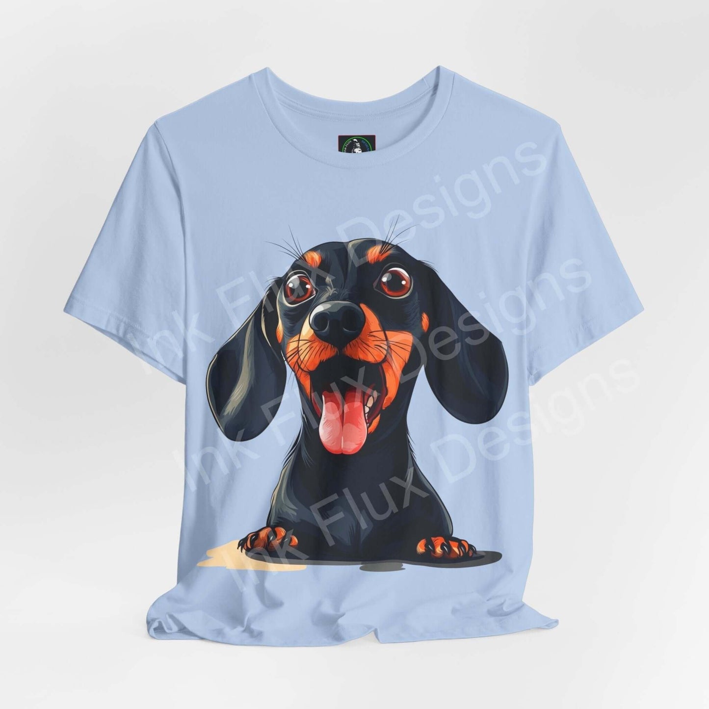 Unisex light blue T-shirt featuring a vibrant graphic of a Dachshund with a playful expression, designed by Bella+Canvas, perfect for dog lovers.