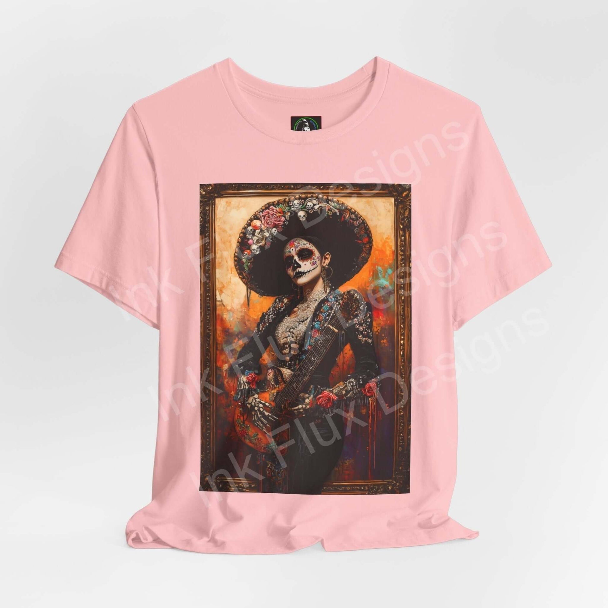 Pink Day of the Dead-themed T-shirt featuring a graphic of a Charro woman in traditional DÃa de Muertos attire, ideal for those seeking cultural and stylish graphic tees.