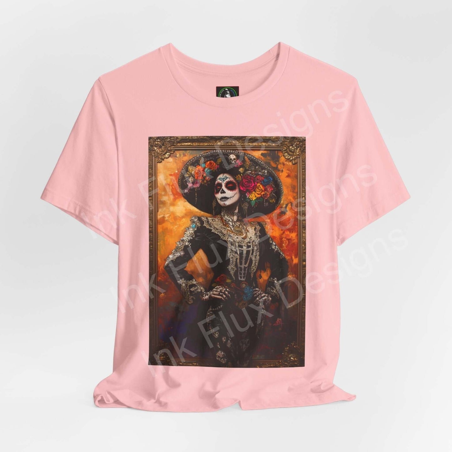 Pink Day of the Dead T-shirt featuring a graphic of a Charro woman with traditional makeup and costume, ideal for DÃa de Muertos celebrations.
