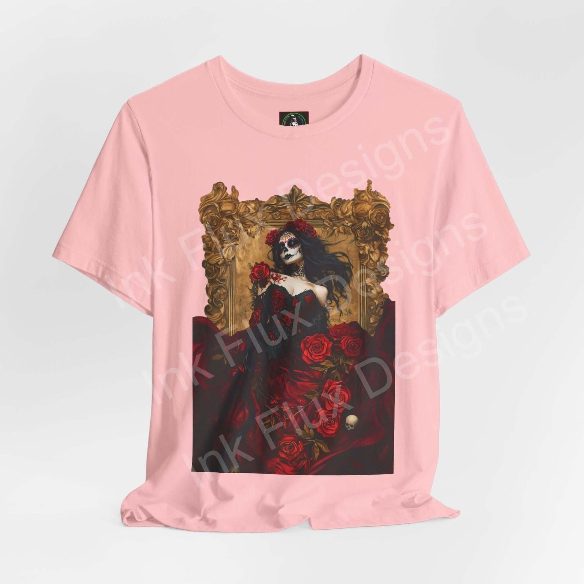Pink Day of the Dead T-shirt featuring a graphic of a woman adorned with roses and a skeleton face, ethically made by Bella+Canvas.