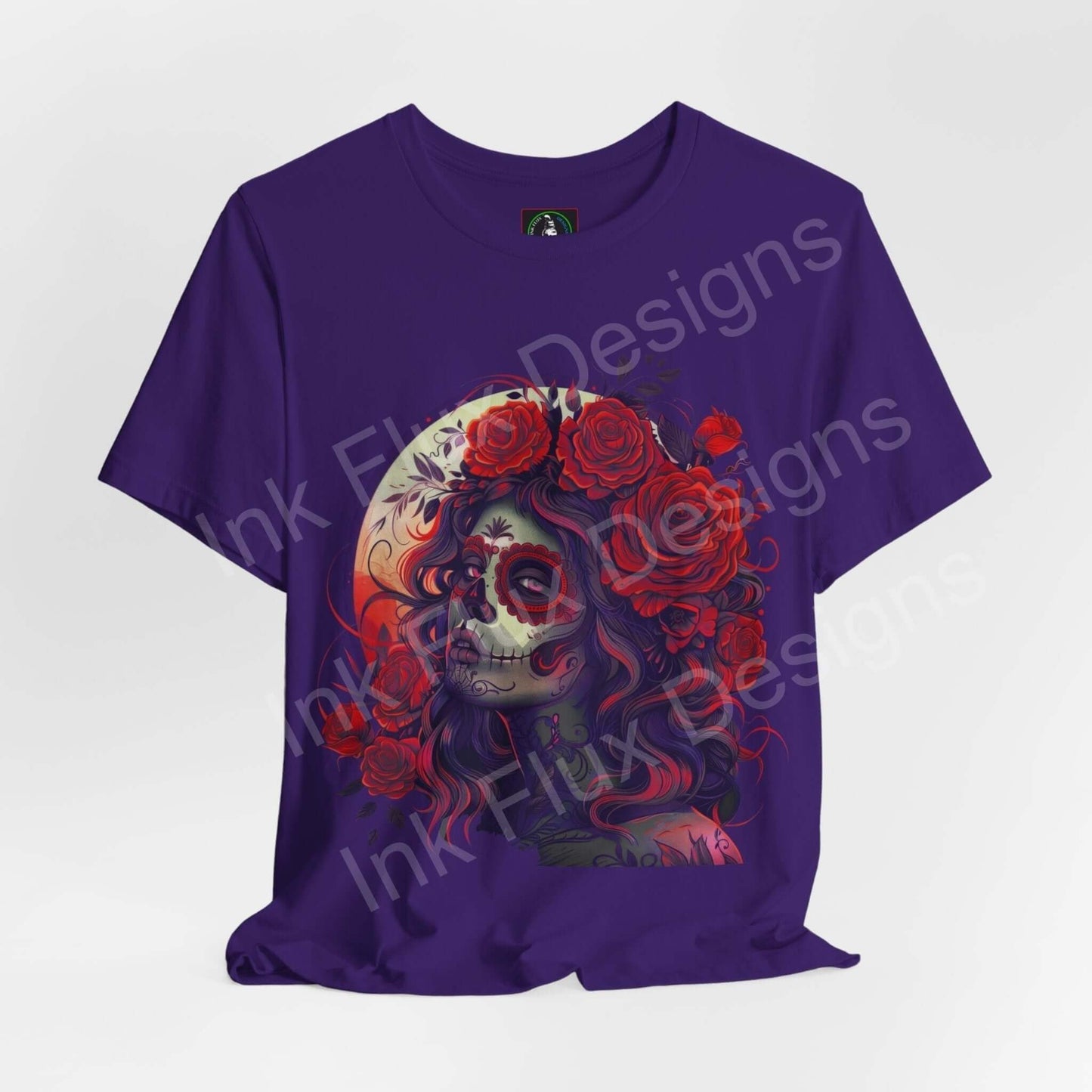 Day of the Dead themed graphic tee featuring a vibrant DÃa de Muertos skull and rose design on a purple T-shirt.