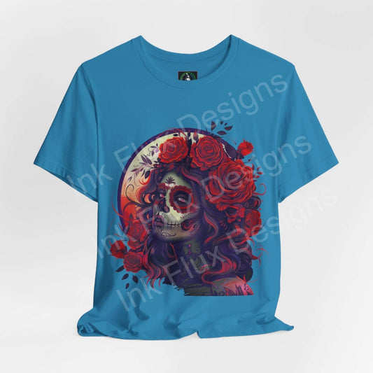 Day of the Dead themed graphic tee featuring a vibrant DÃa de Muertos skull design with floral accents, on a blue unisex T-shirt.