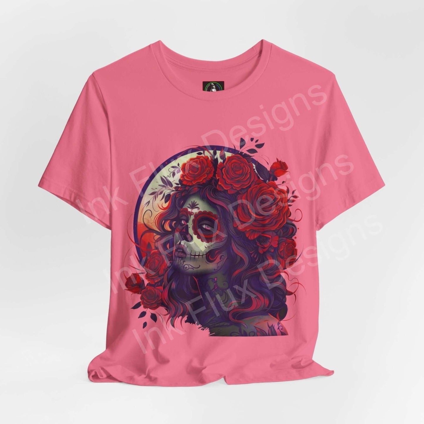 Pink Day of the Dead T-shirt featuring a vibrant DÃa de Muertos graphic with floral details, designed by Bella+Canvas for style and comfort.
