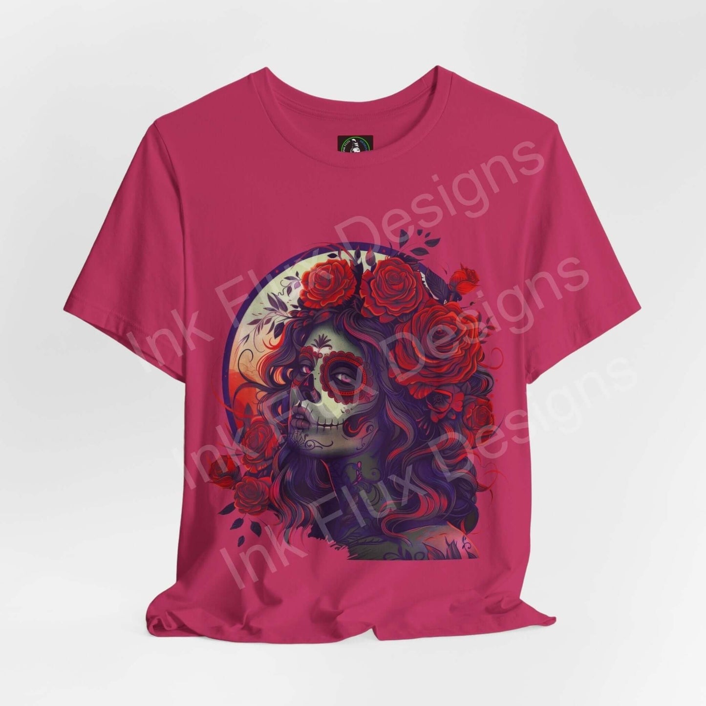 Vibrant pink Day of the Dead themed graphic tee featuring a detailed DÃa de Muertos skull design surrounded by roses, ideal for anyone seeking unique, culturally-inspired shirts.