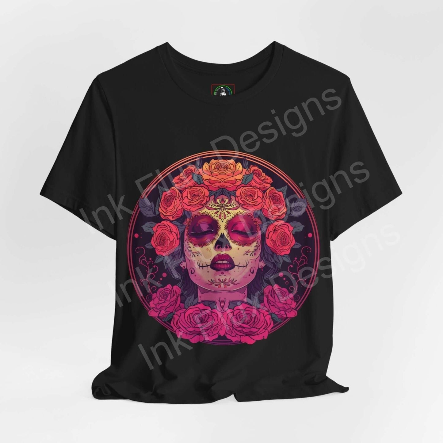 Black unisex T-shirt featuring a vibrant Day of the Dead graphic with a skull adorned with roses, celebrating DÃa de Muertos.