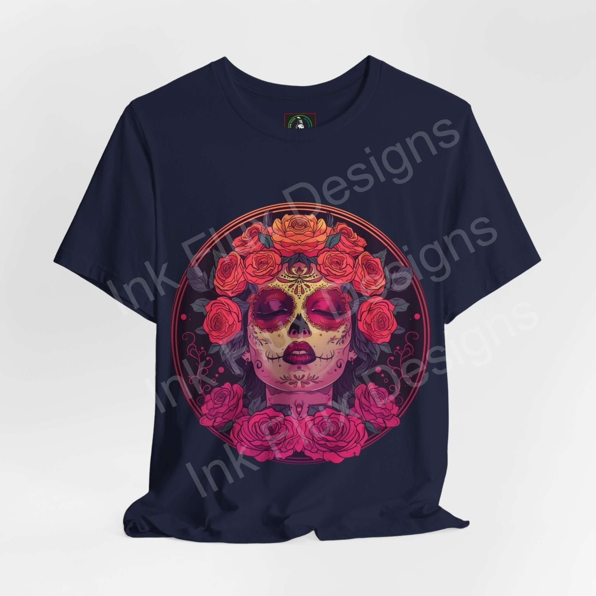 Navy blue Day of the Dead themed graphic tee featuring a vibrant DÃa de Muertos skull with floral crown design on a unisex T-shirt by Bella+Canvas.