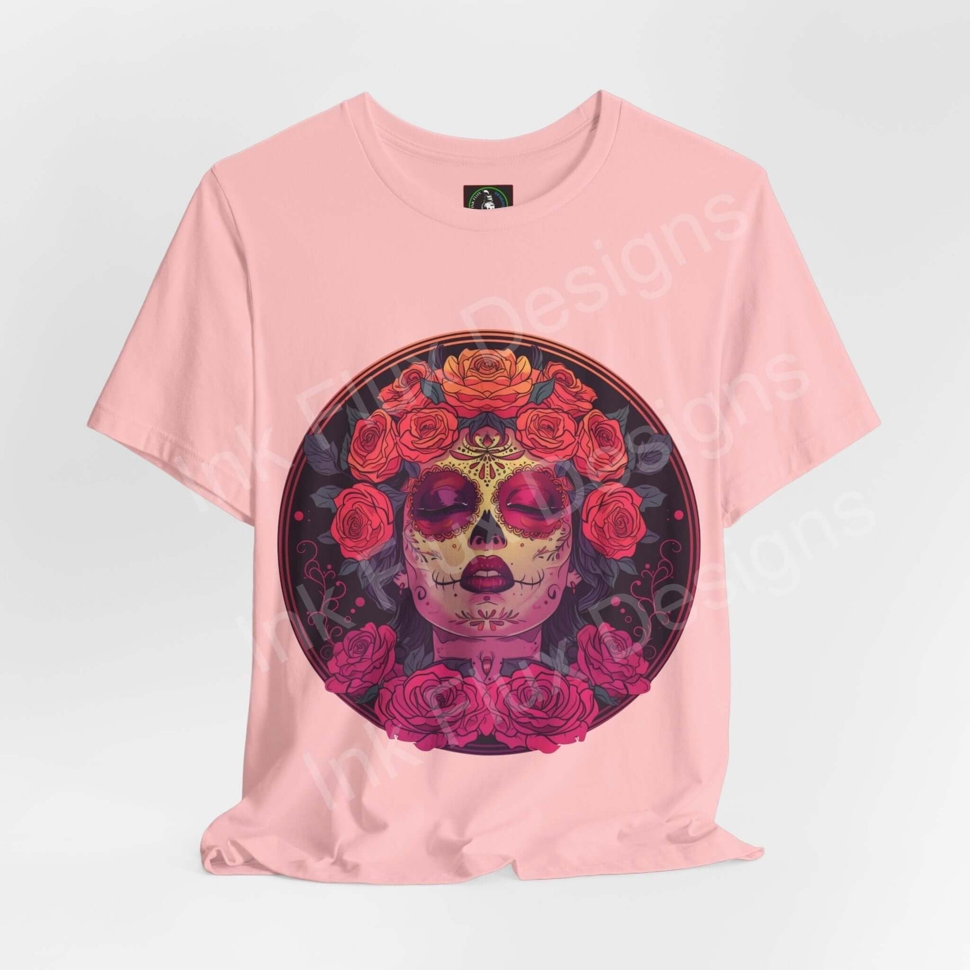 Pink unisex T-shirt featuring a large Day of the Dead graphic with a colorful skull and rose design, from the Day of the Dead III collection.