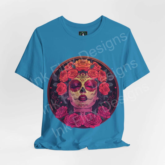 Blue unisex Day of the Dead graphic tee featuring a vibrant DÃa de Muertos skull design with rose embellishments.
