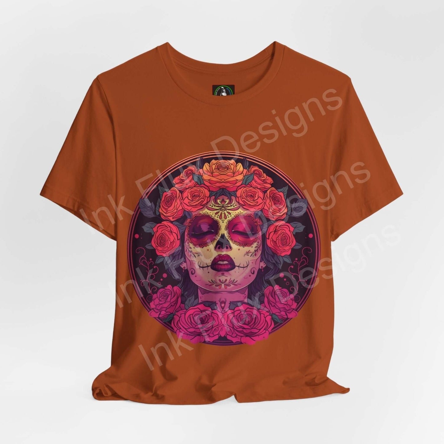 Day of the Dead themed graphic tee featuring a colorful skull and roses design on a rust-colored shirt, ideal for DÃa de Muertos celebrations.