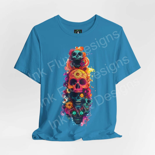 Vibrant Day of the Dead graphic tee featuring colorful skulls and floral patterns on a turquoise T-shirt, ideal for DÃa de Muertos celebrations.