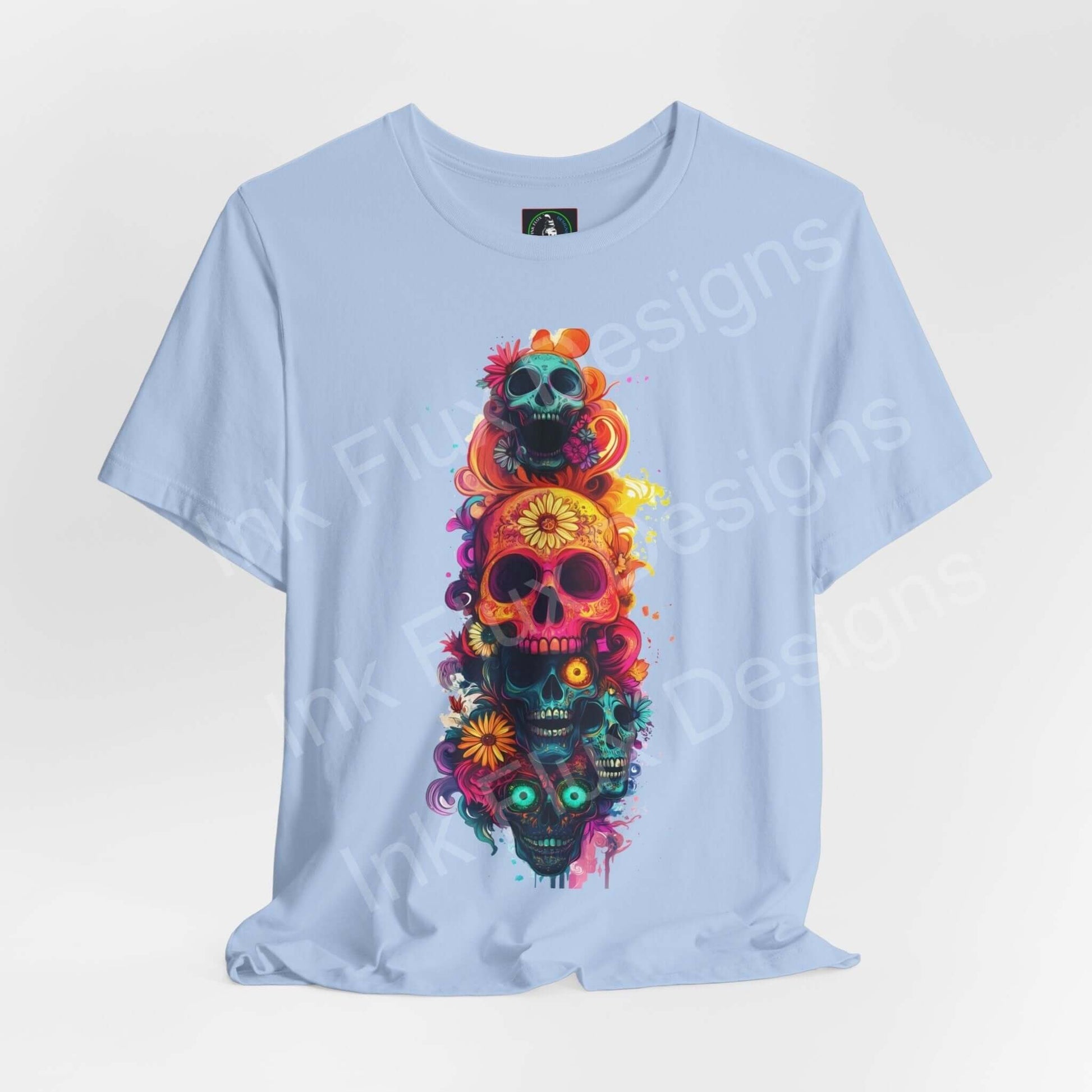 Light blue unisex T-shirt featuring colorful Day of the Dead skulls design, ideal for DÃa de Muertos themed graphic tees.