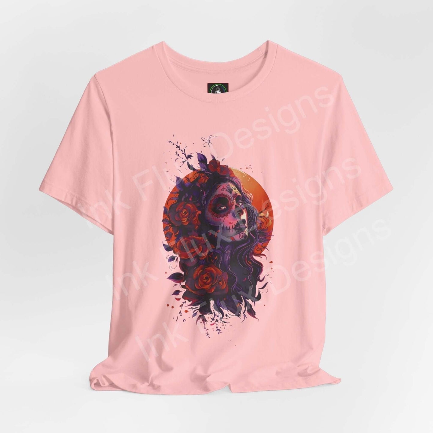 Pink Day of the Dead themed graphic tee with vibrant sugar skull and rose design, ideal for DÃa de Muertos celebrations.