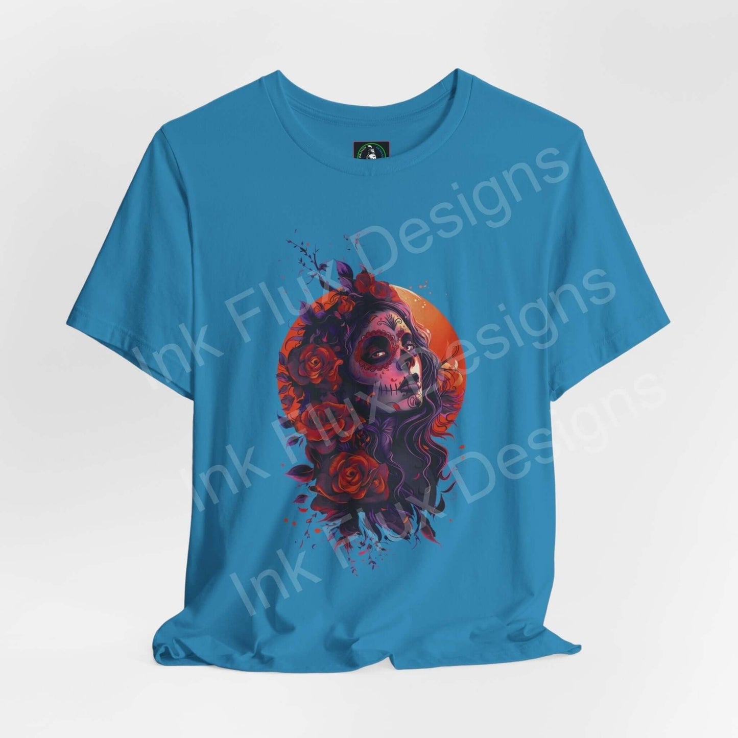 Day of the Dead themed graphic tee in blue, featuring a vibrant DÃa de Muertos skull and roses design, perfect for style and comfort.