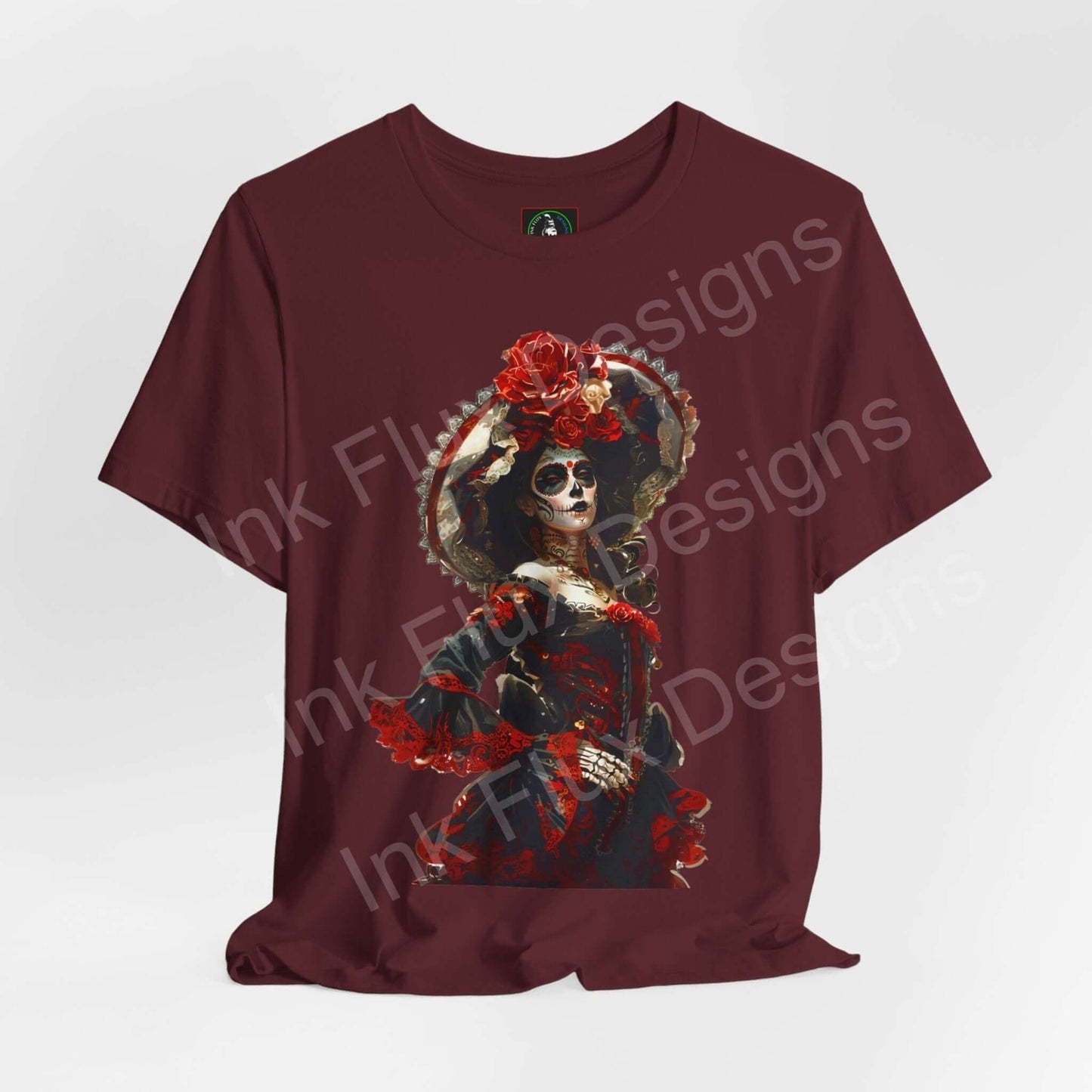 Day of the Dead themed graphic tee featuring a vibrant DÃa de Muertos skull design on a maroon shirt, ideal for cultural events and casual wear.