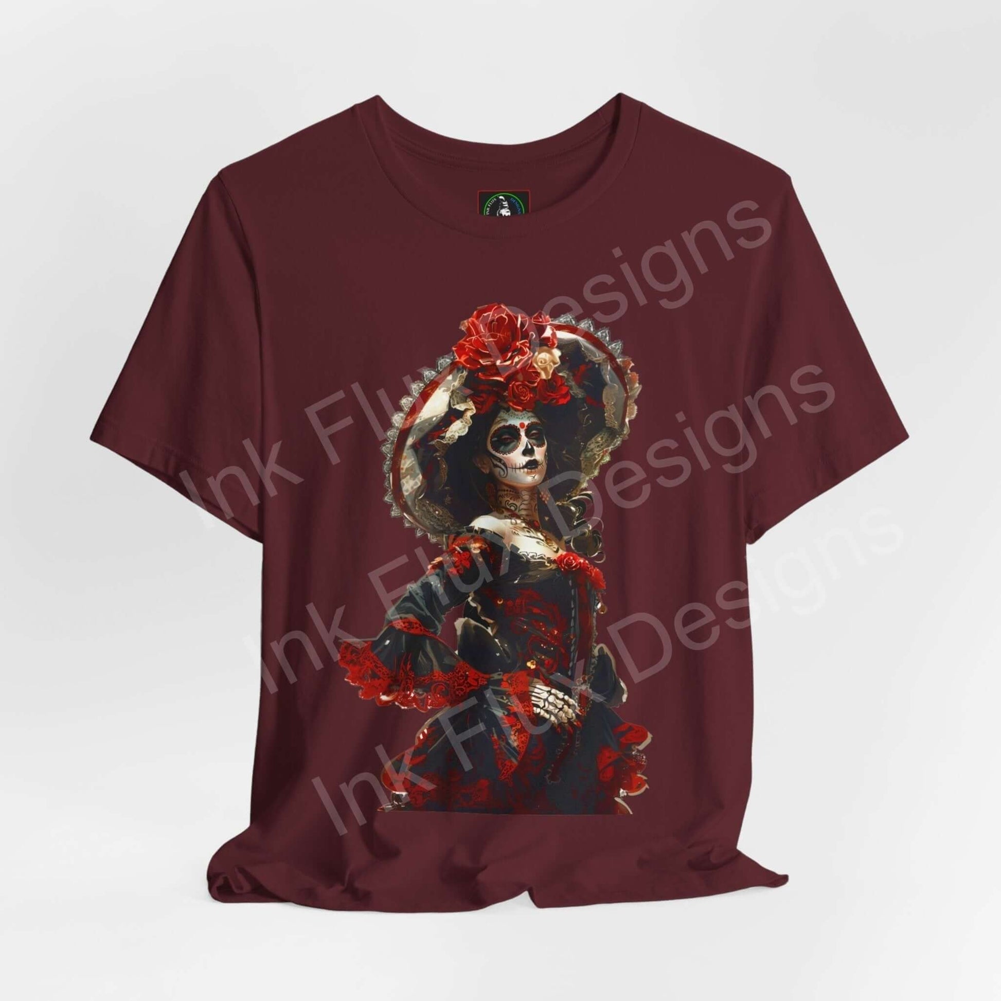 Day of the Dead themed graphic tee featuring a vibrant DÃa de Muertos skull design on a maroon shirt, ideal for cultural events and casual wear.