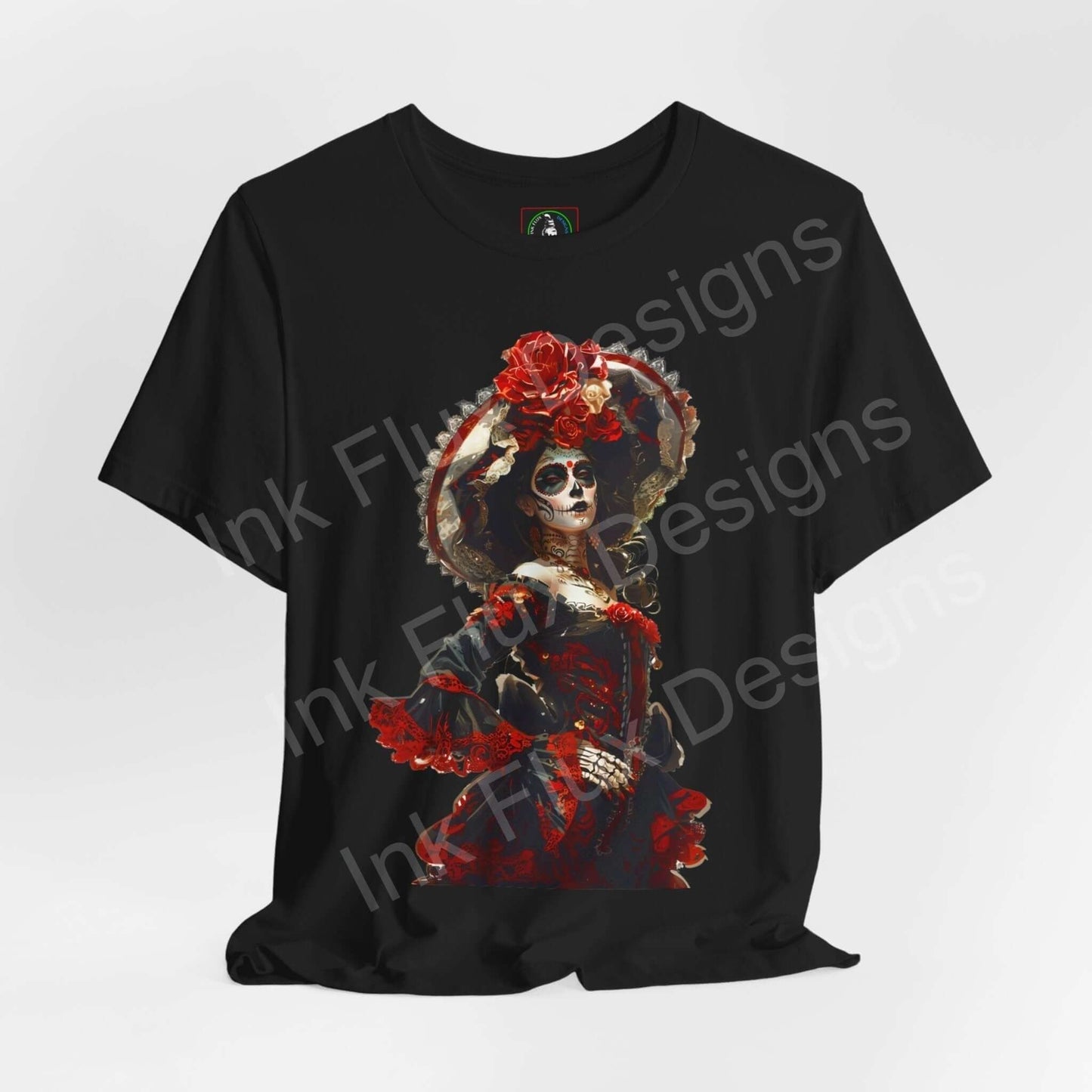 Black unisex T-shirt featuring a vibrant Day of the Dead graphic with a skull and red floral accents, ethically made by Bella+Canvas.