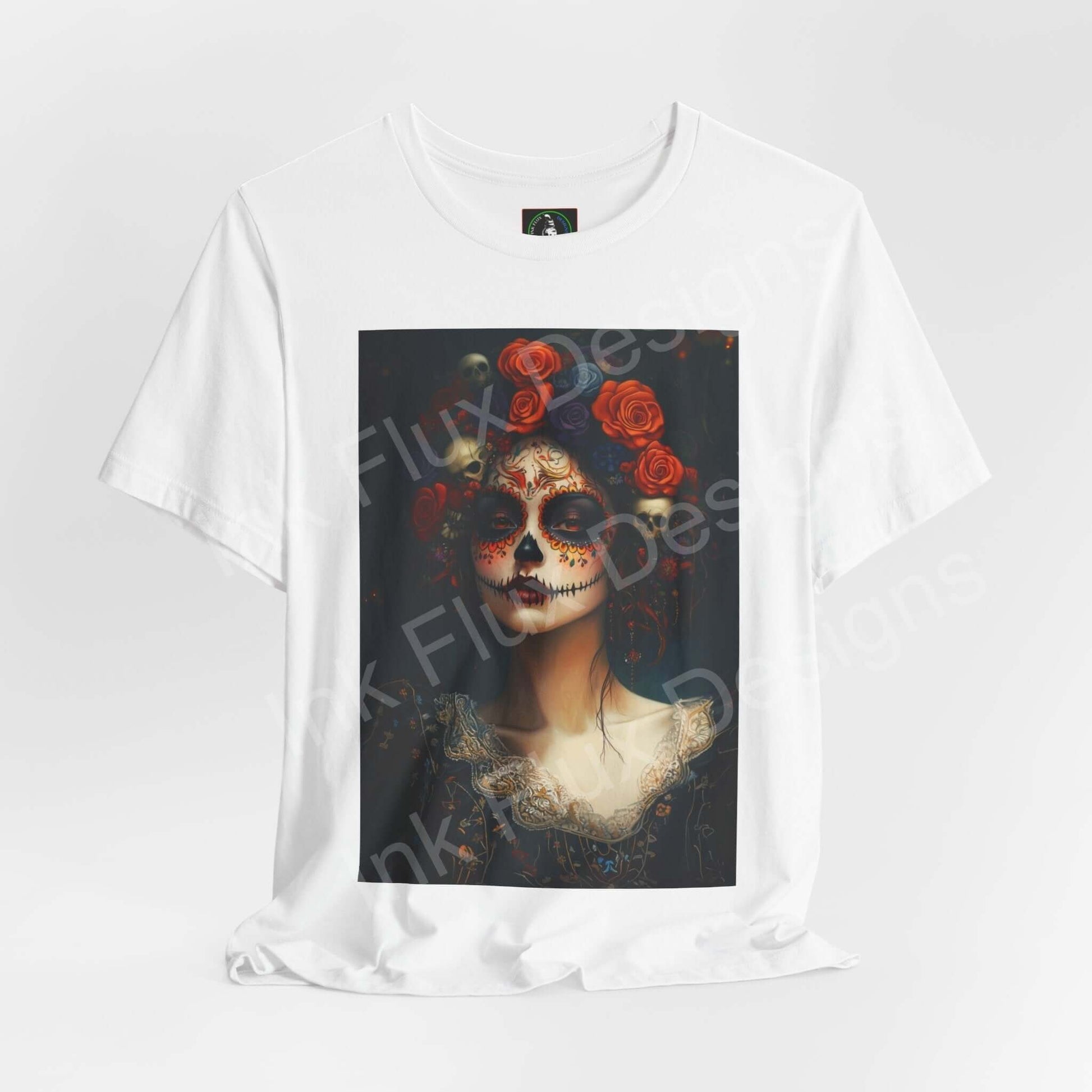 Day of the Dead-themed graphic tee featuring a woman's portrait with traditional DÃa de Muertos makeup and rose adornments on a white T-shirt.