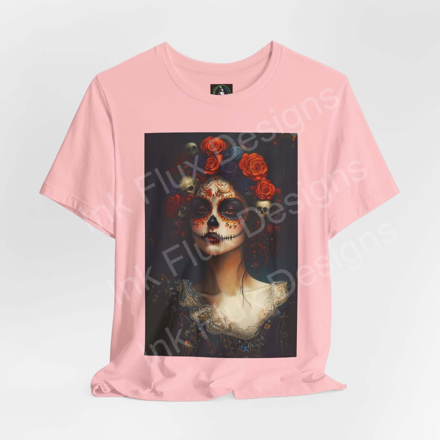 Pink Day of the Dead unisex T-shirt featuring a graphic print of a woman with traditional DÃa de Muertos makeup and floral headpiece.