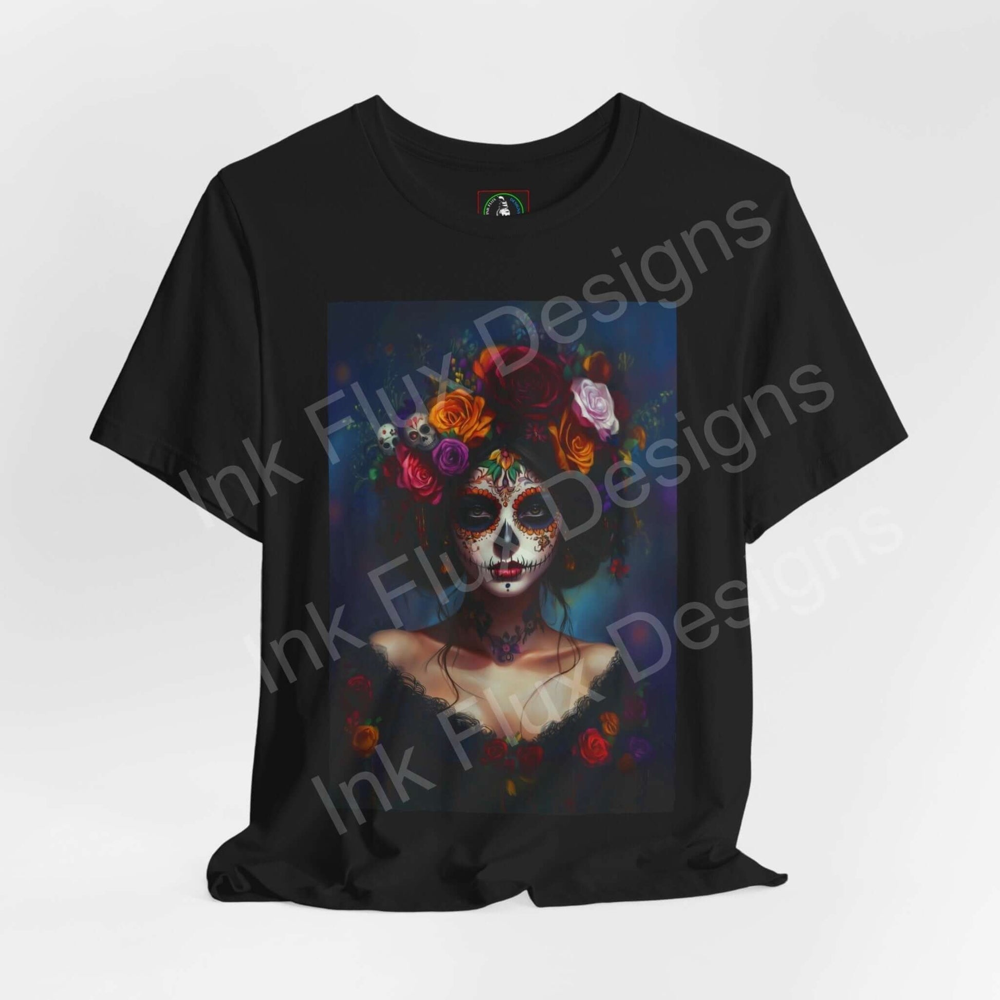 Graphic tee featuring a Day of the Dead portrait design, with vibrant floral embellishments and traditional DÃa de Muertos makeup, on a black T-shirt.