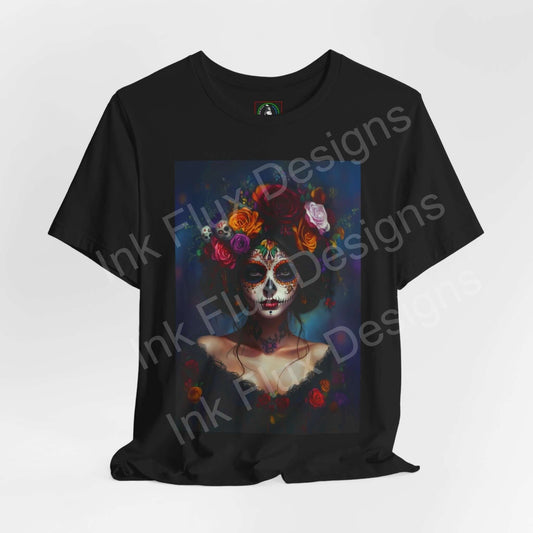 Graphic tee featuring a Day of the Dead portrait design, with vibrant floral embellishments and traditional DÃa de Muertos makeup, on a black T-shirt.